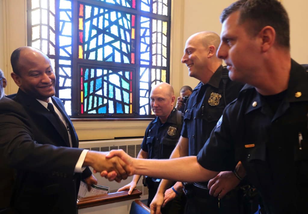 First responders shaking hands at a community event